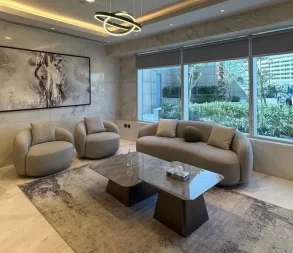 Comfortable seating area with contemporary furniture and large windows.