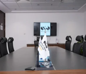 Modern conference room at World Trade Center Riyadh with screen and flags.