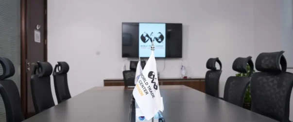 Modern conference room at World Trade Center Riyadh with screen and flags.