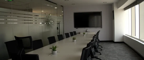 Spacious conference room with large screen and modern furniture in Riyadh.