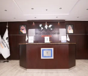 Reception desk at World Trade Center Riyadh with flags and signage.