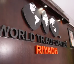 Interior view of World Trade Center Riyadh logo and signage in office lobby.