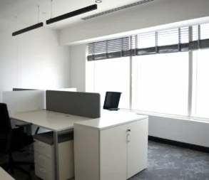 Bright office with large windows and modern furniture in Riyadh.