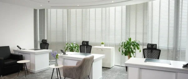 Contemporary office with large windows and modern furniture in Riyadh.