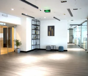 Spacious, well-lit office lobby with contemporary decor and seating area.