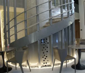 Contemporary interior with spiral staircase and seating area in Riyadh.