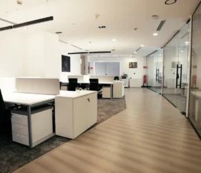 Spacious, modern office with workstations and glass walls in Riyadh.