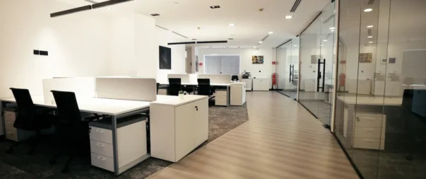 Spacious, modern office with workstations and glass walls in Riyadh.